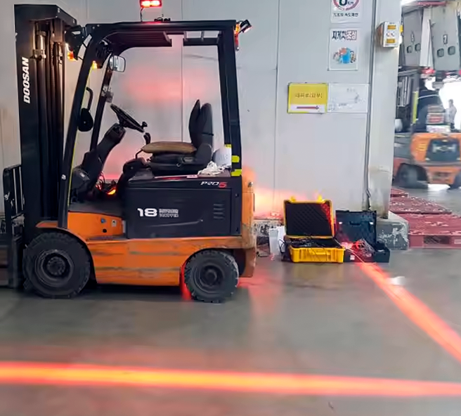 A forklift tripping a light curtain beam.